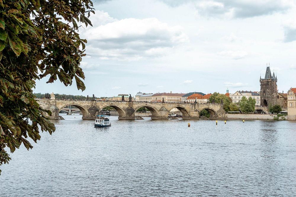 The Charles Bridge over the river, with its neat arches and a tower at the end.