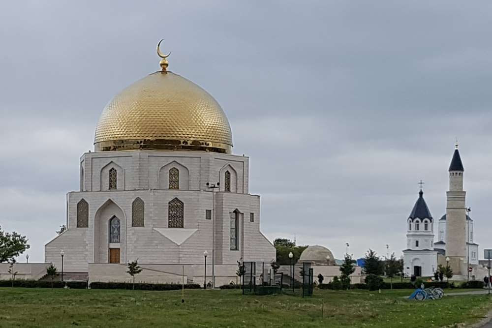 A large, mult-sided building - maybe 8 sides? - with a large gold dome on top, and a small half-moon on top of that. 