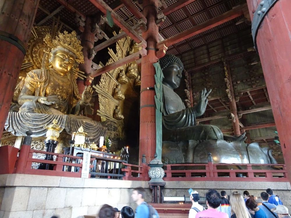 Inside the temple, two large statues presumably of the buddha. The one on the left is gold, while the one on the right is some darker metal.