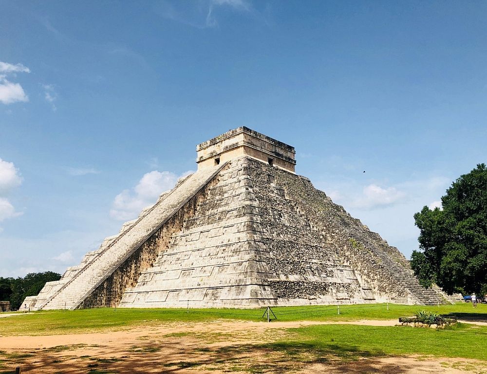 A pyramid, with stepped sides and a stairway up to the top, which has a flat platform.