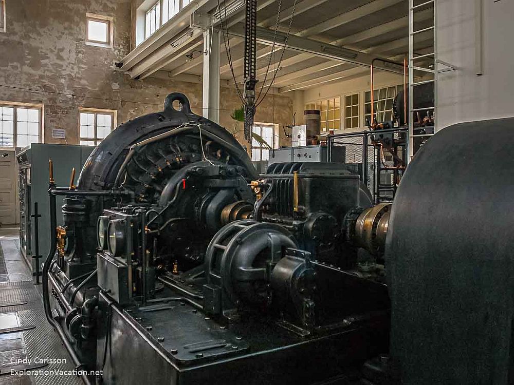 A room full of heavy black metal machinery at Grimeton. It looks more like a turbine for a steam engine.