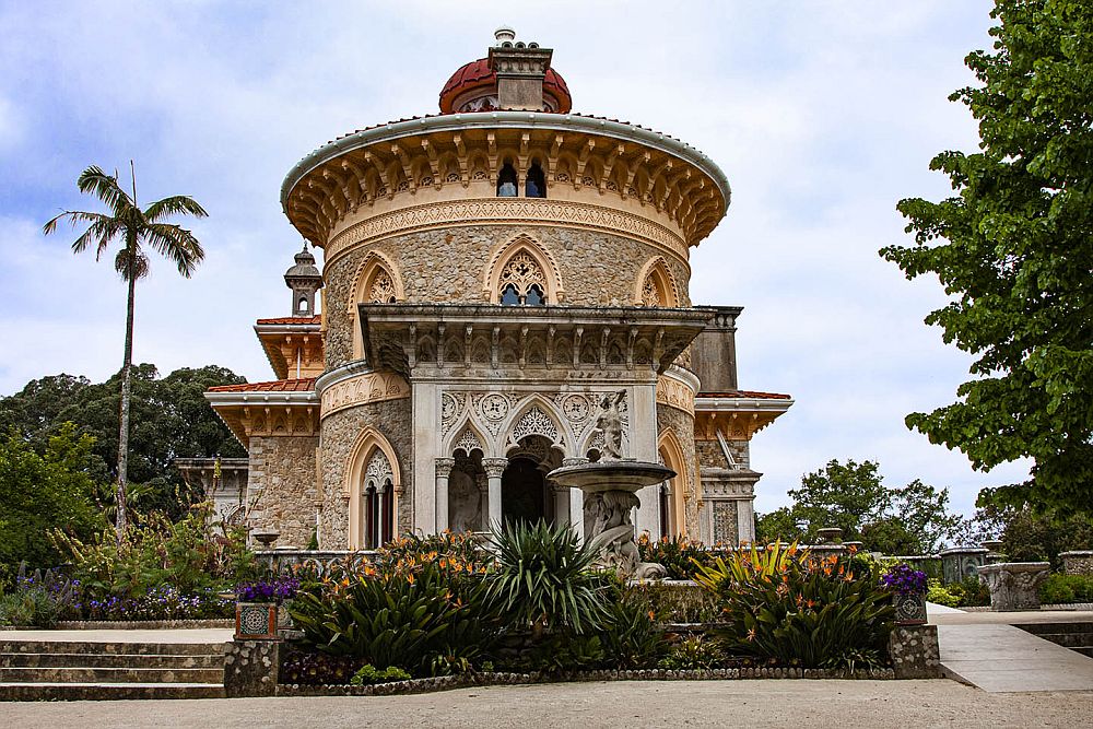 A round, 2-3 story structure with stone walls, an ornate Arabic-inspired entrance and window frames.