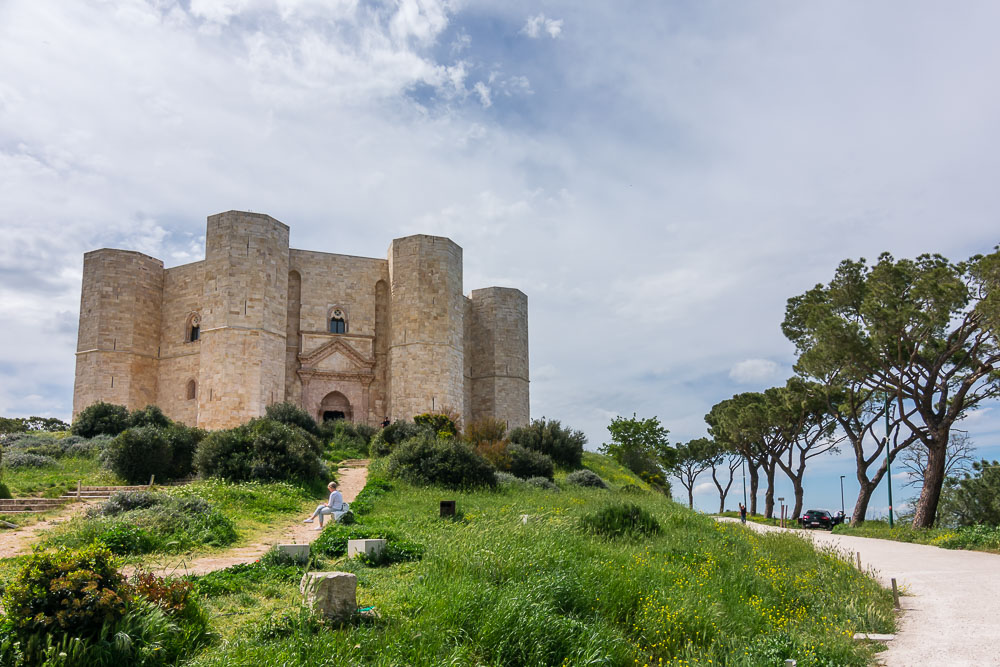 A view looking up the drive to the castle. It stands on a hill, and in this photo four of the octagonal towers show, with two of them framing the main entrance.