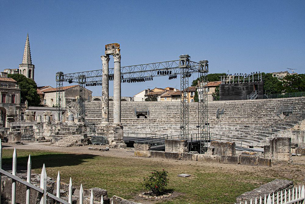 A steep, rounded bank of seats, with two tall columns in front of them.