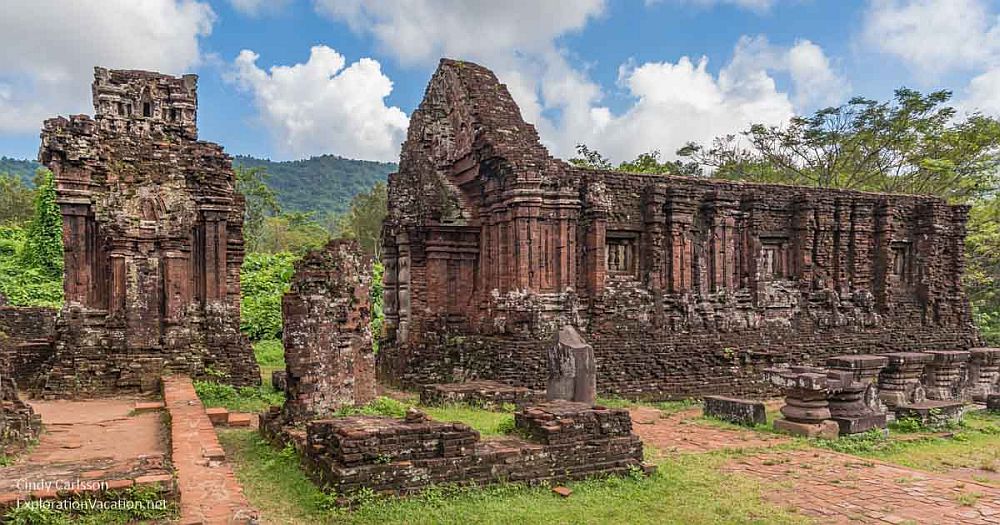 Ruins of a temple at My Son Sanctuary in Vietnam: stone, intricately carved, with walls but no roof.