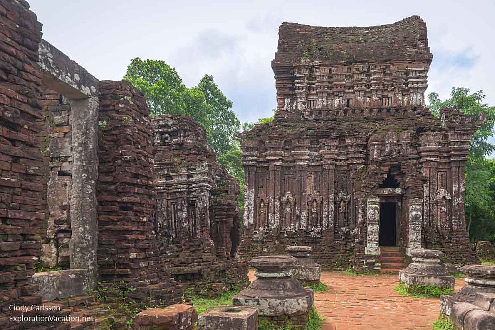 A ruin of a temple at My Son Sanctuary in Vietnam. Some of the original carvings are still visible on the walls, while some parts are eroded to the brick.