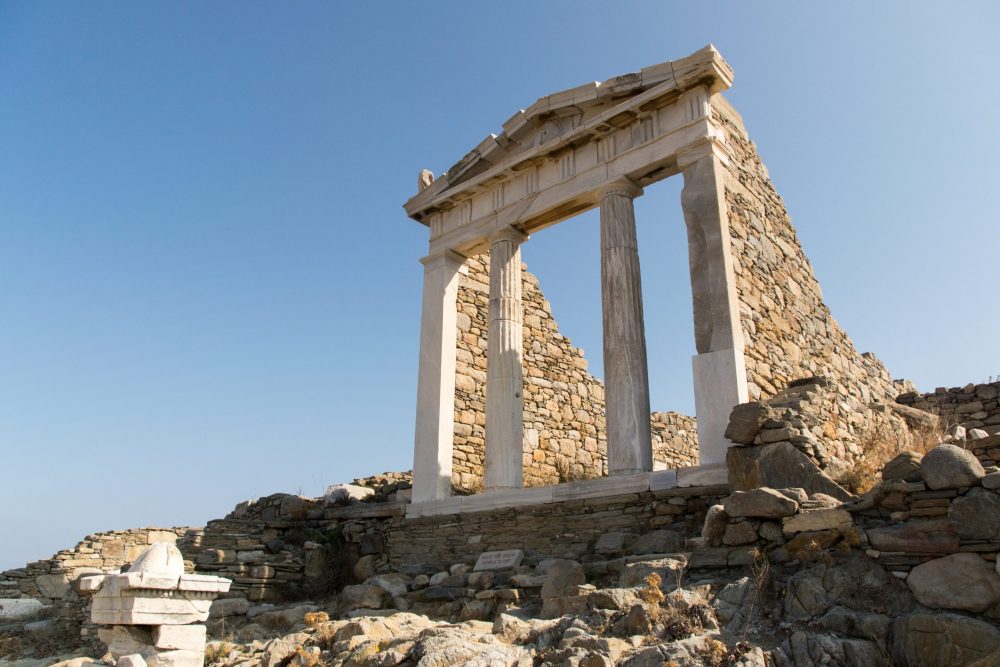 At Delos, a ruin of what looks like it might have been a temple: four tall columns supporting a triangular pediment.