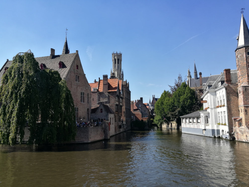 Looking down a canal in Brugge, with a variety of medieval buildings on either side.
