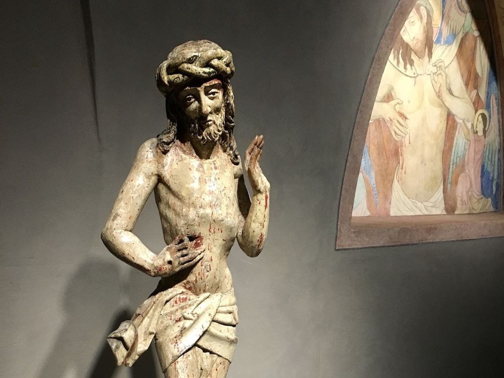 A medieval-period carved statue of Jesus.