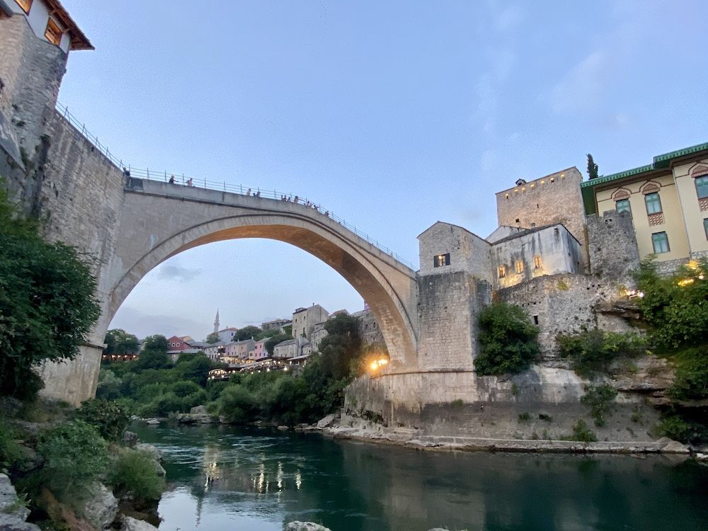 The Old Bridge in Mostar: high above the water, a wide arch.