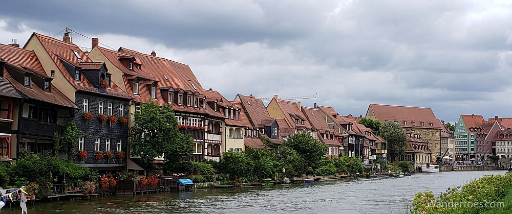 A row of pretty medieval buildings/houses along a river in Bamberg, Germany.