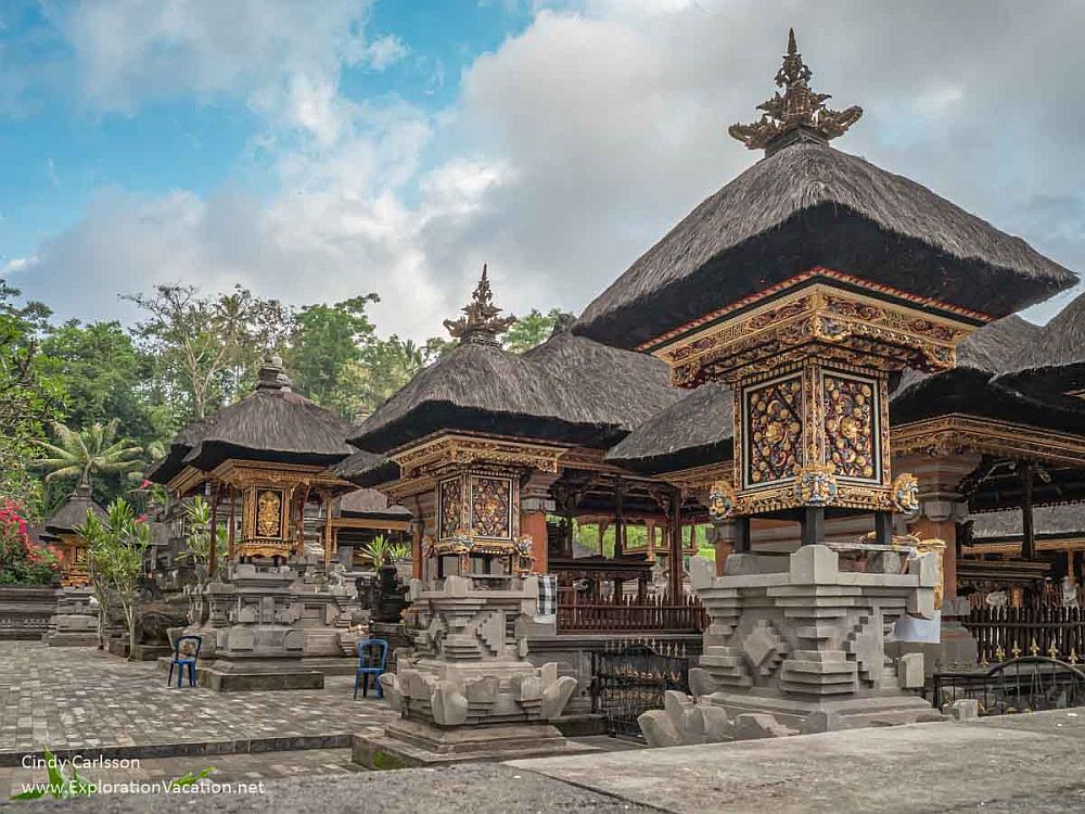 A temple with ornate pillars with neat thatched roofs.