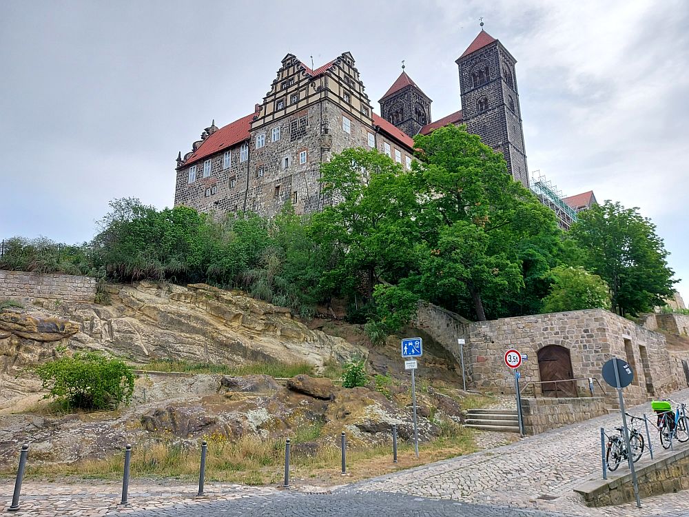 Looking up at the castle and church in Quedlinburg. They stand on a rise, the two square towers of the church in the center.