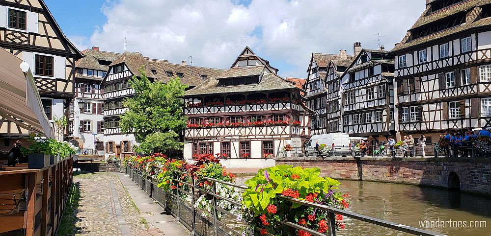 A cluster of pretty half-timbered buildings with balconies and colorful flower boxes.