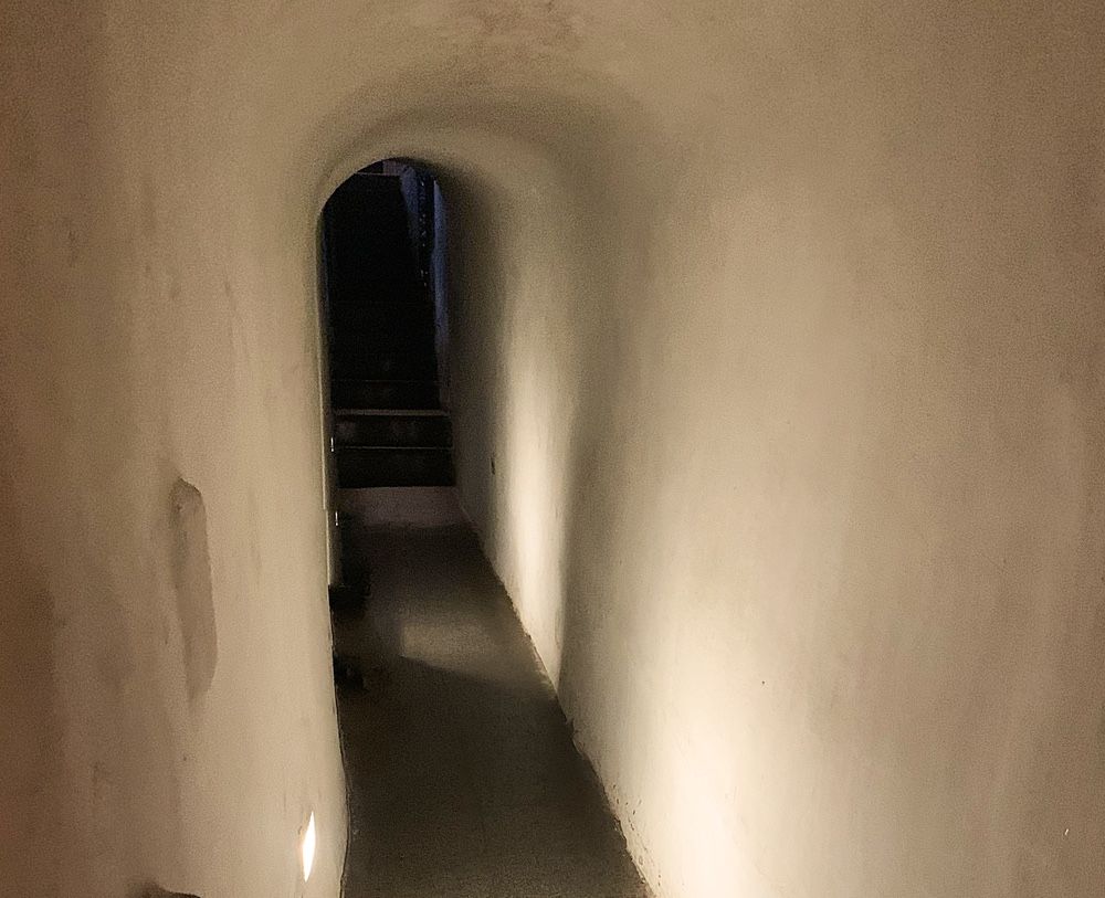A simple white-walled tunnel, only wide enough for one person at a time.
