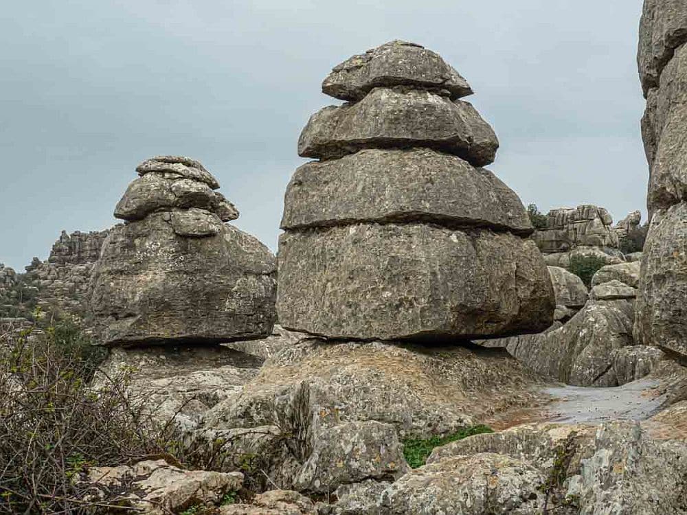 Rock formations that taper from top to bottom, looking like stacks of separate rocks piled up.