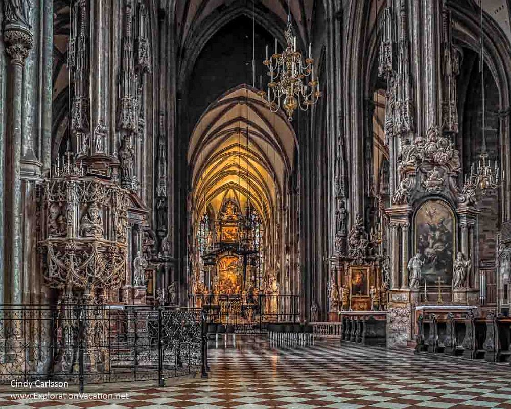 Ornately detailed cathedral interior: gothic arches, but also very detailed baroque altars and other decorative additions.