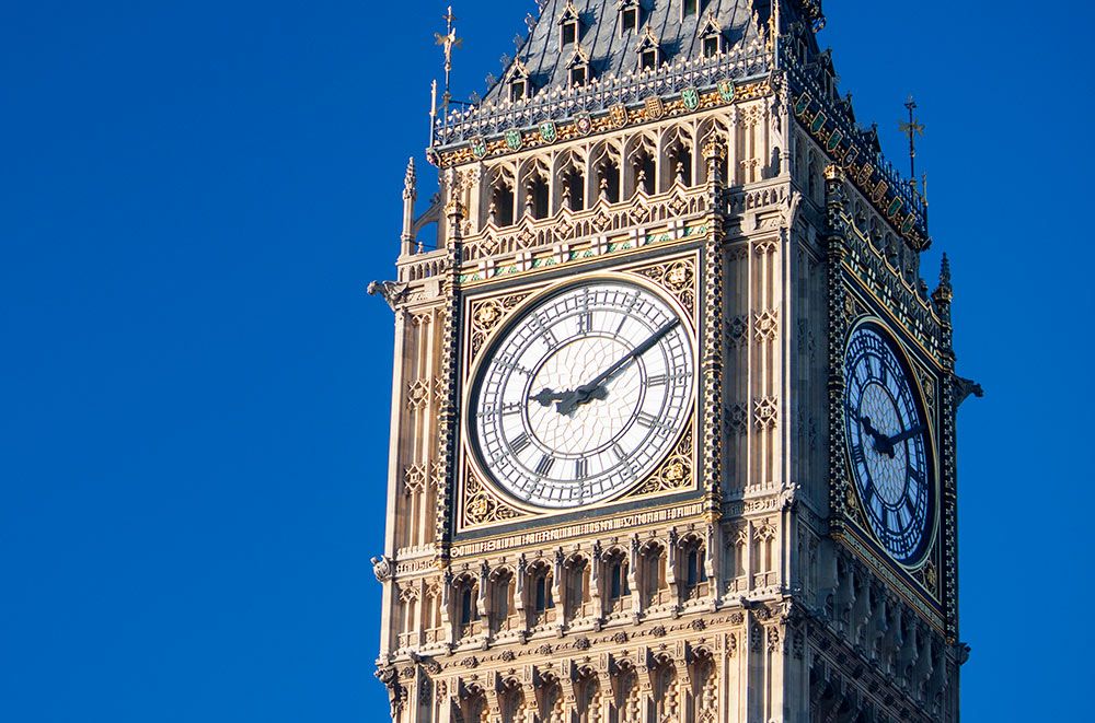 The newly-restored top section of Big Ben, with its ornate stone work and huge clock.