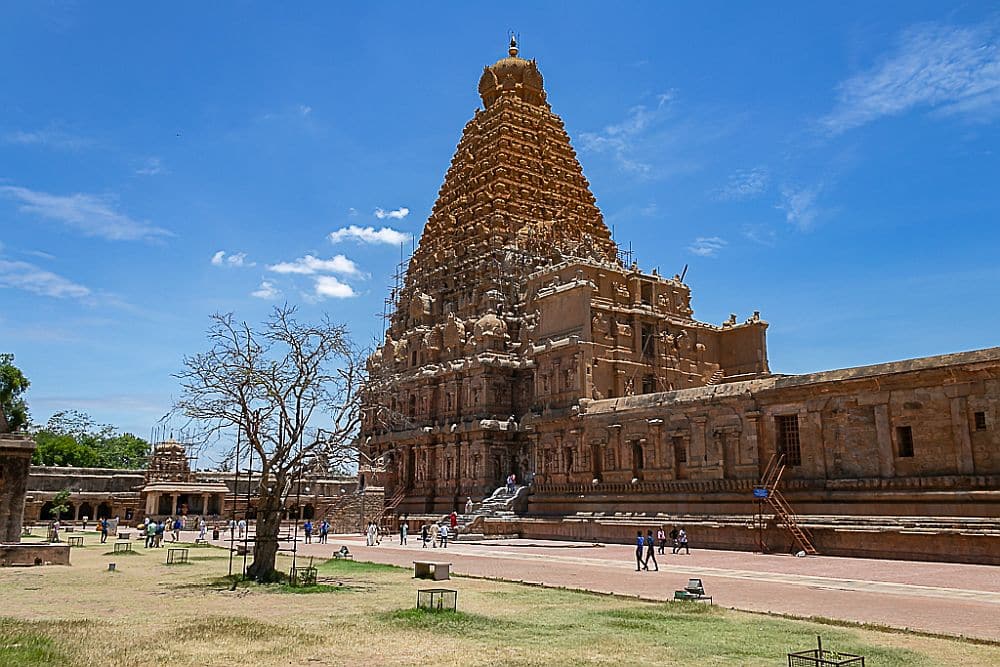 A temple with a tall pyramid-shaped roof, covered in carvings.