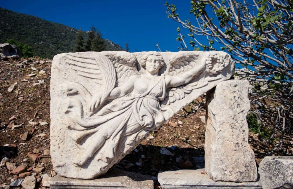 An image of the god Nike as a woman with wings, carved in a stone block at Ephesus.