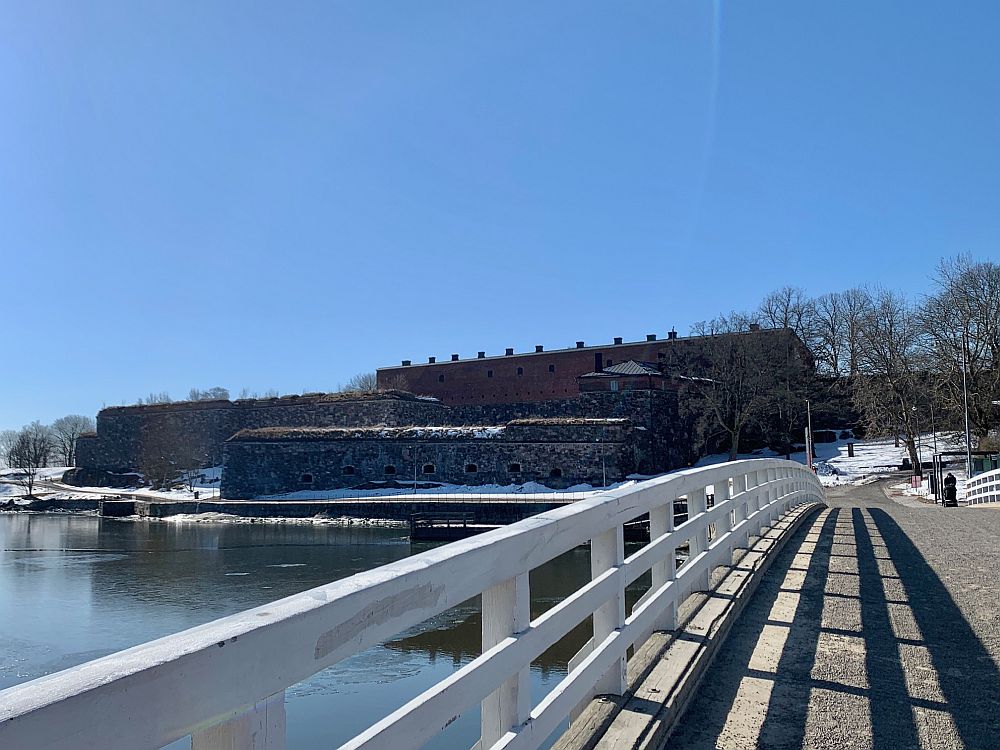 Seen from a bridge over a body of water, the fortress walls are visible.