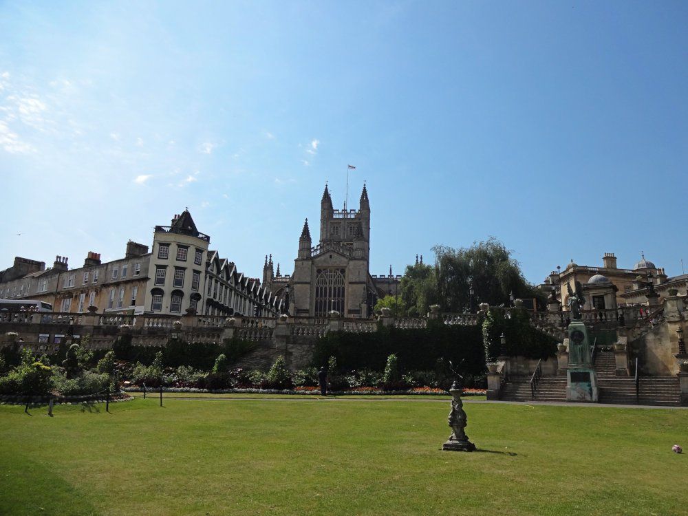 Gothic-style abbey as seen from across the green lawn of the Parade Garden in Bath.