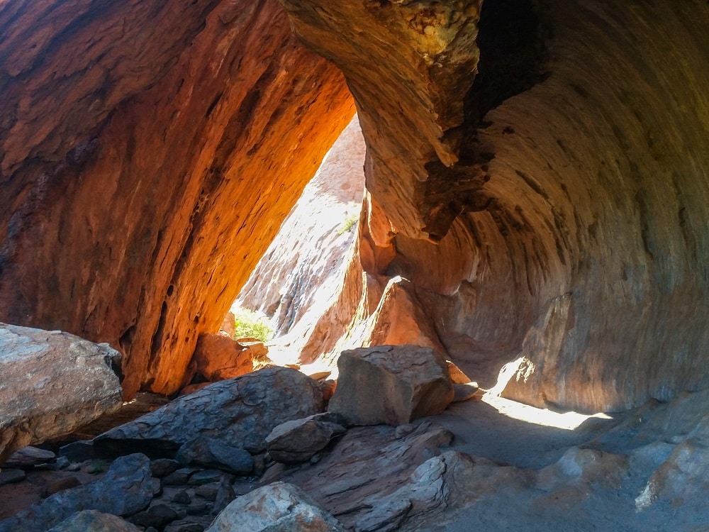 Looking out from a dark rock cave.