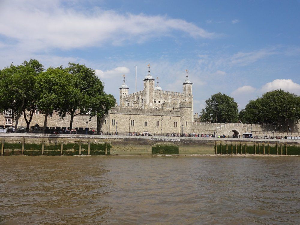 The Tower of London seen from the River Thames, looking every bit the classic castle.