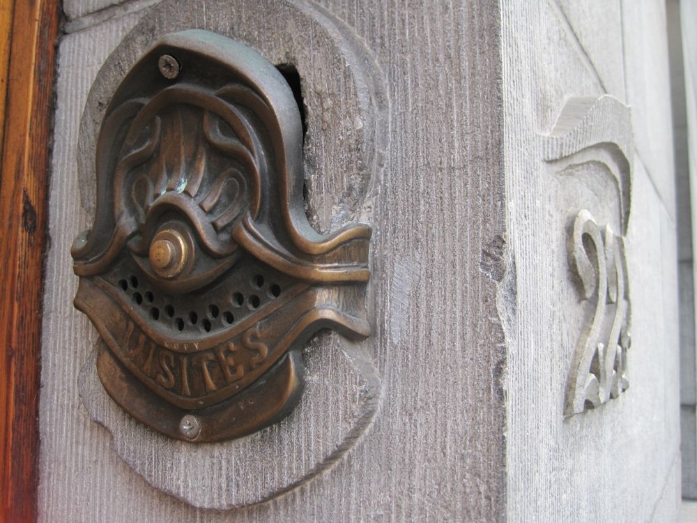 Close-up of a doorbell with art deco style on the Hotel Solvay.