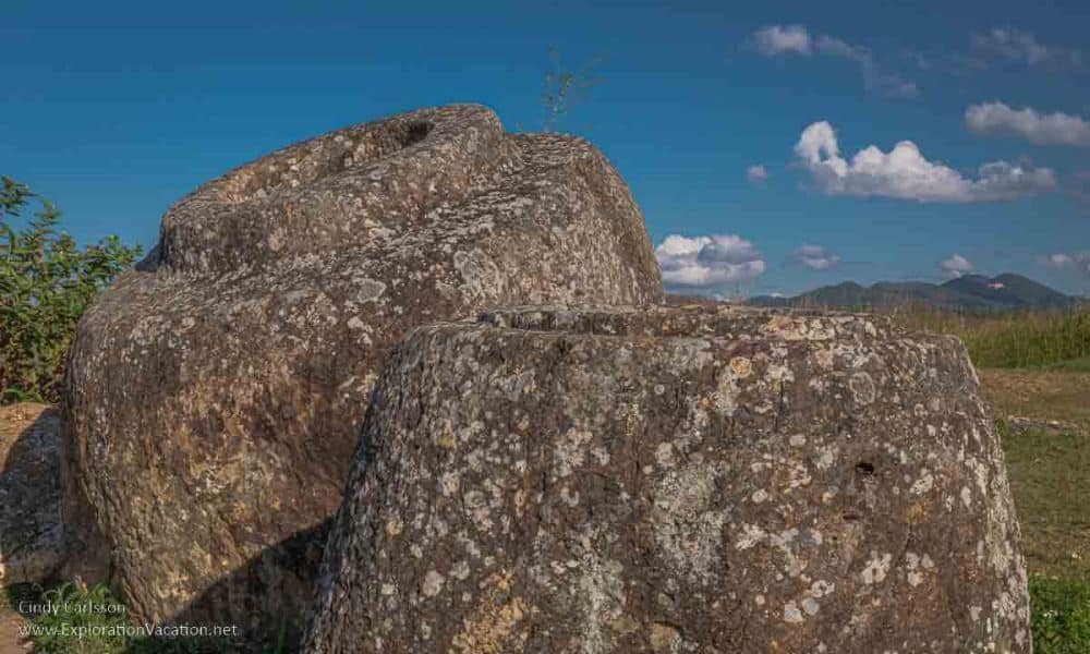 A close-up of two of the jars: rough-carved granite, quite thick-sided.