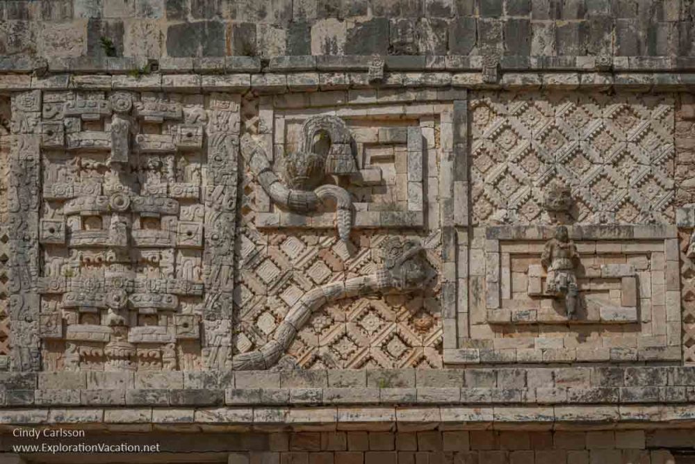 A carved detail showing two snakes on a patterned background.