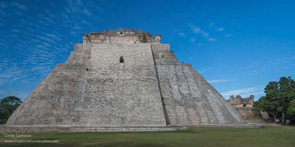 A very tall and very steep stone pyramid with a flat top.