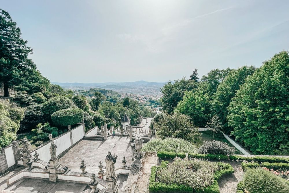 View down over the stairway, the gardens on either side, and the city of Braga in the distance.