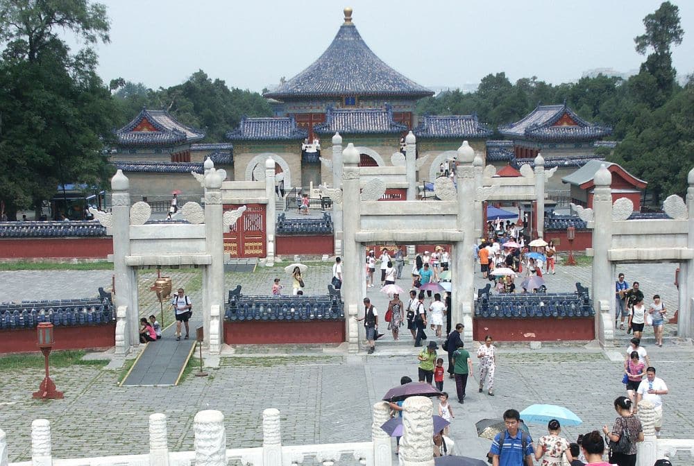 View over an entrance area of stone gateways with a pagoda in the back