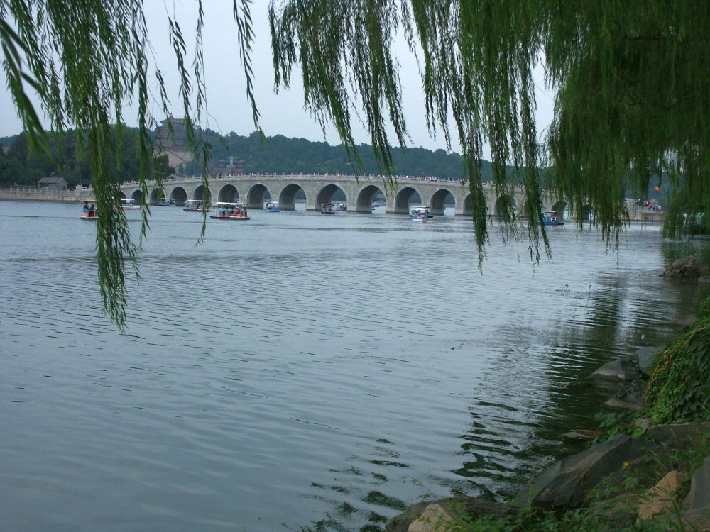 Seen across an expanse of lake, a gently curving bridge on 17 arches.