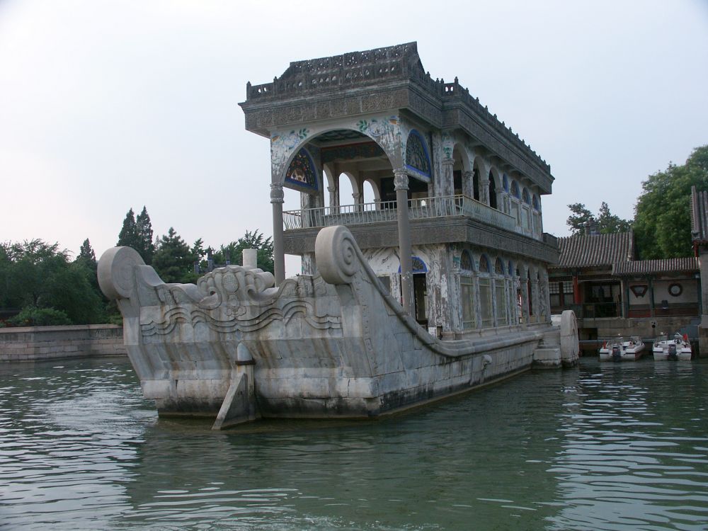 A boat made out of gray marble looks like it's floating.