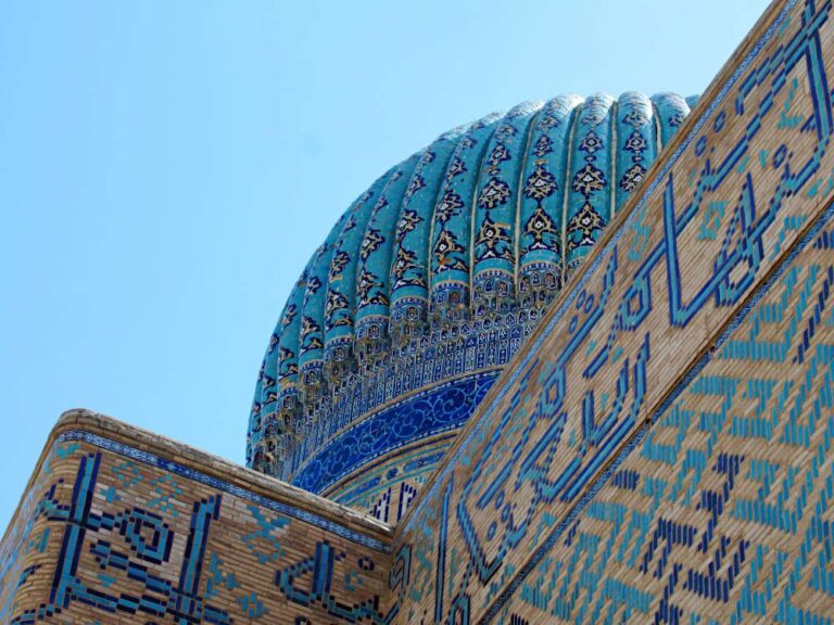 Looking up at a dome on the mausoleum showing beautiful decorative tile work.