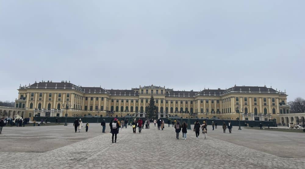 Front view of Schonbrunn palace seen from a distance to fit such a large structure into the picture.