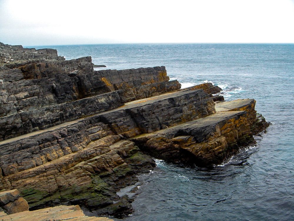 A view of the cliffs, which show distinct layers, each set back from the one below it.