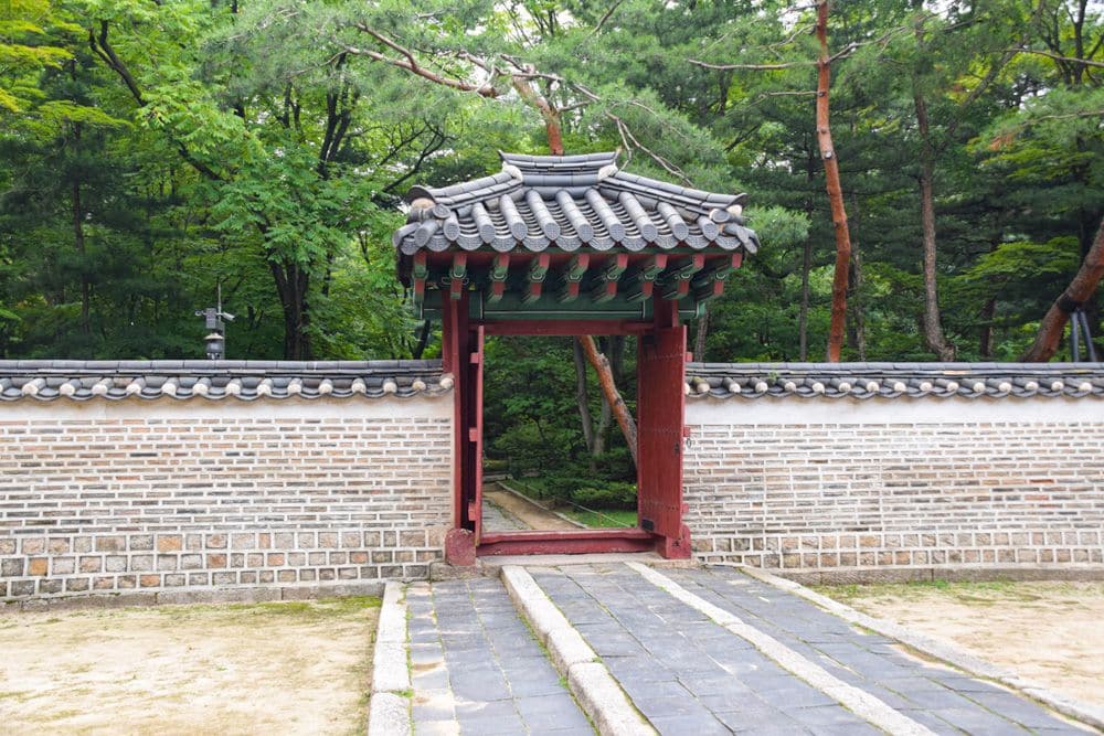 A small gate in a wall with a raised path leading to it - reserved for royalty.