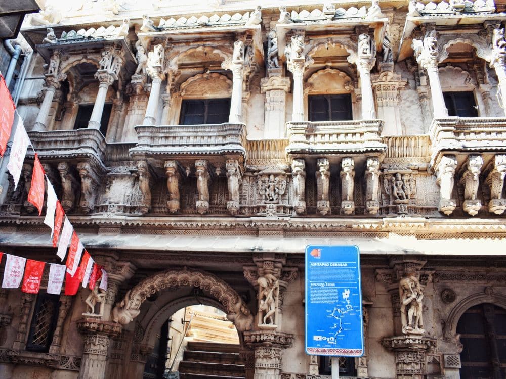 The temple is very ornate, with carved frames with pillars around the upper windows and decorative pillars and archway on the ground floor.