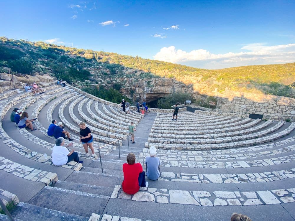 A large outdoor amphitheater with curved rows of stone seats.