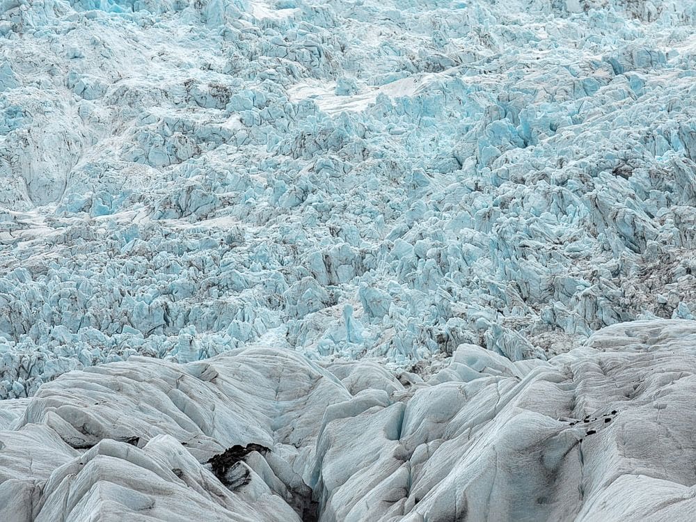 A slope of very bumpy ans jagged blue ice, somewhat smoother toward the bottom.