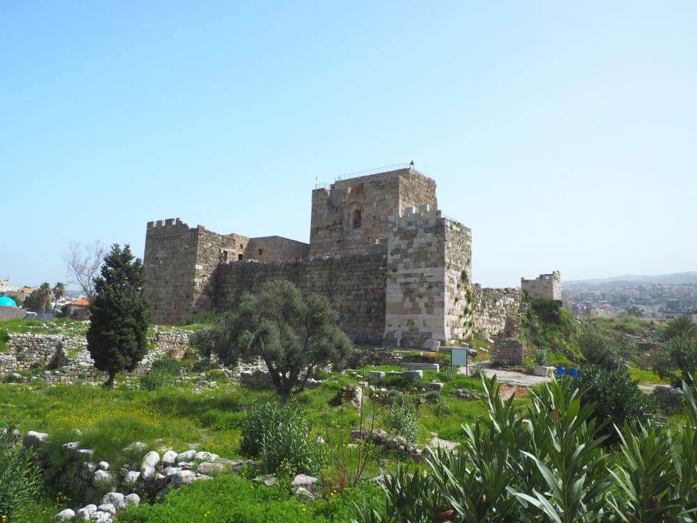 A blockish stone structure with square towers at two corners and a higher section in the middle.