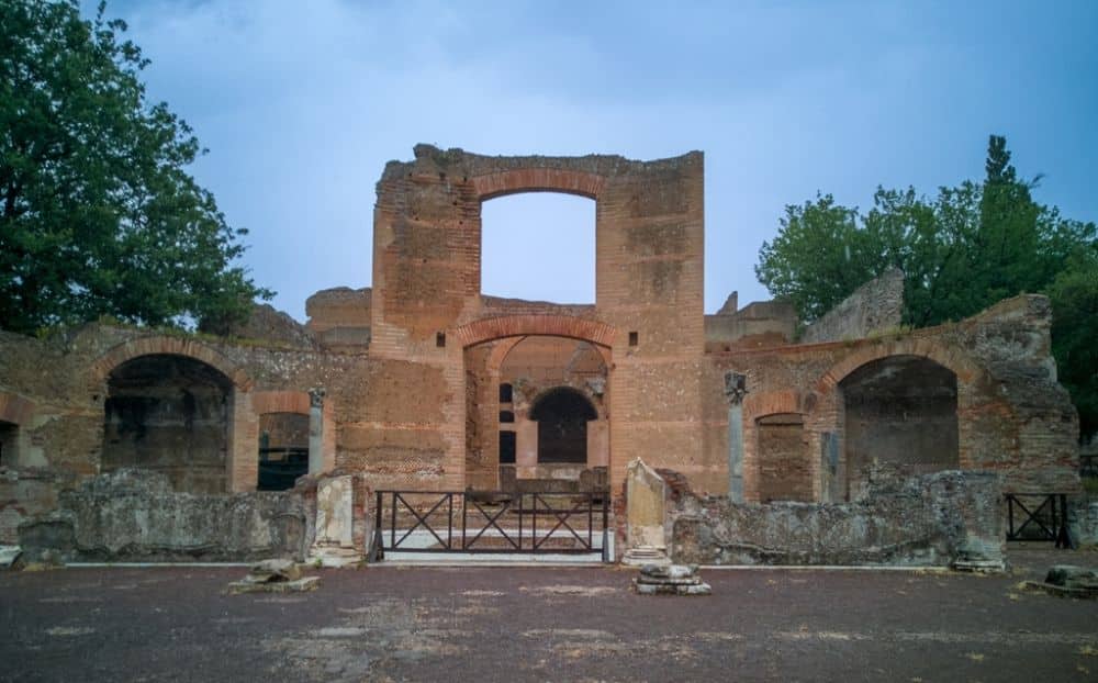 A stone-built ruin with a tall double arch and a number of smaller walls and arches.