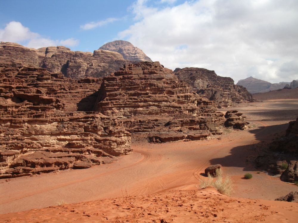 A view of reddish rocky outcroppings above the desert floor.