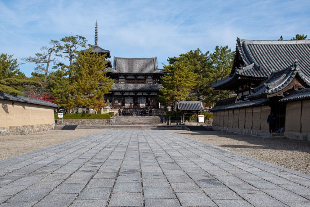 A wide open plaza, with a large building (Niomon central gate) straight ahead.