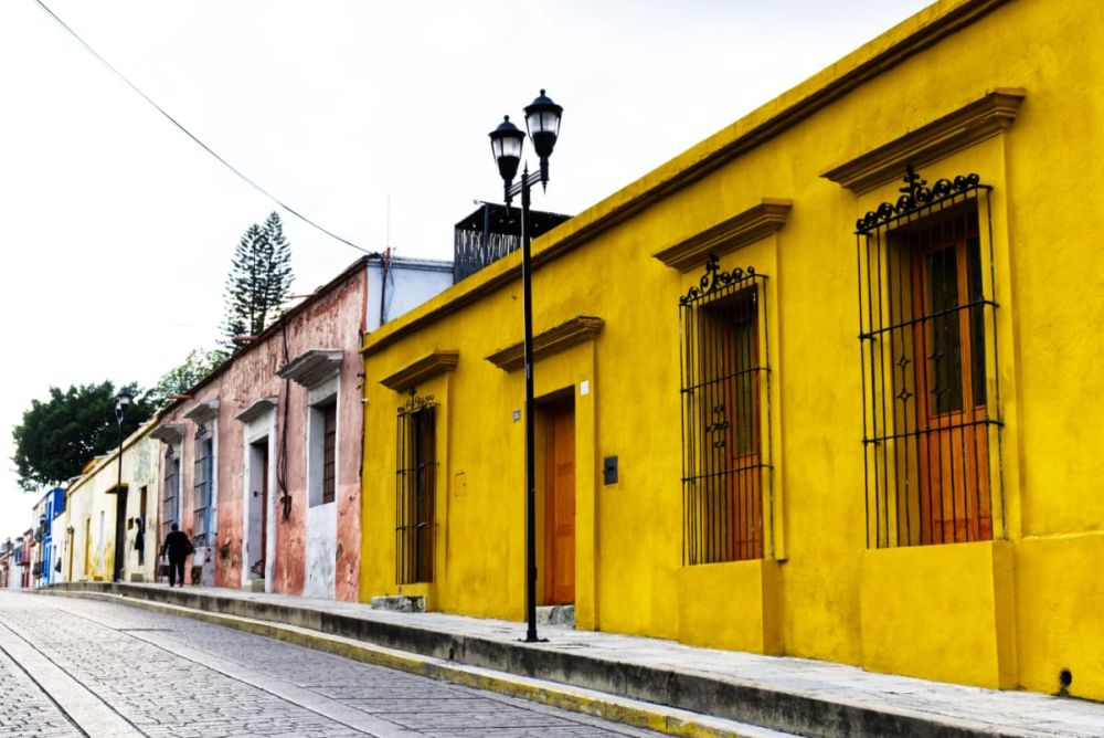 A row of single storey houses painted in bright colors.