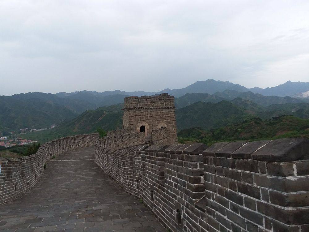 A flat section of the wall, with a range of mountains in the background.