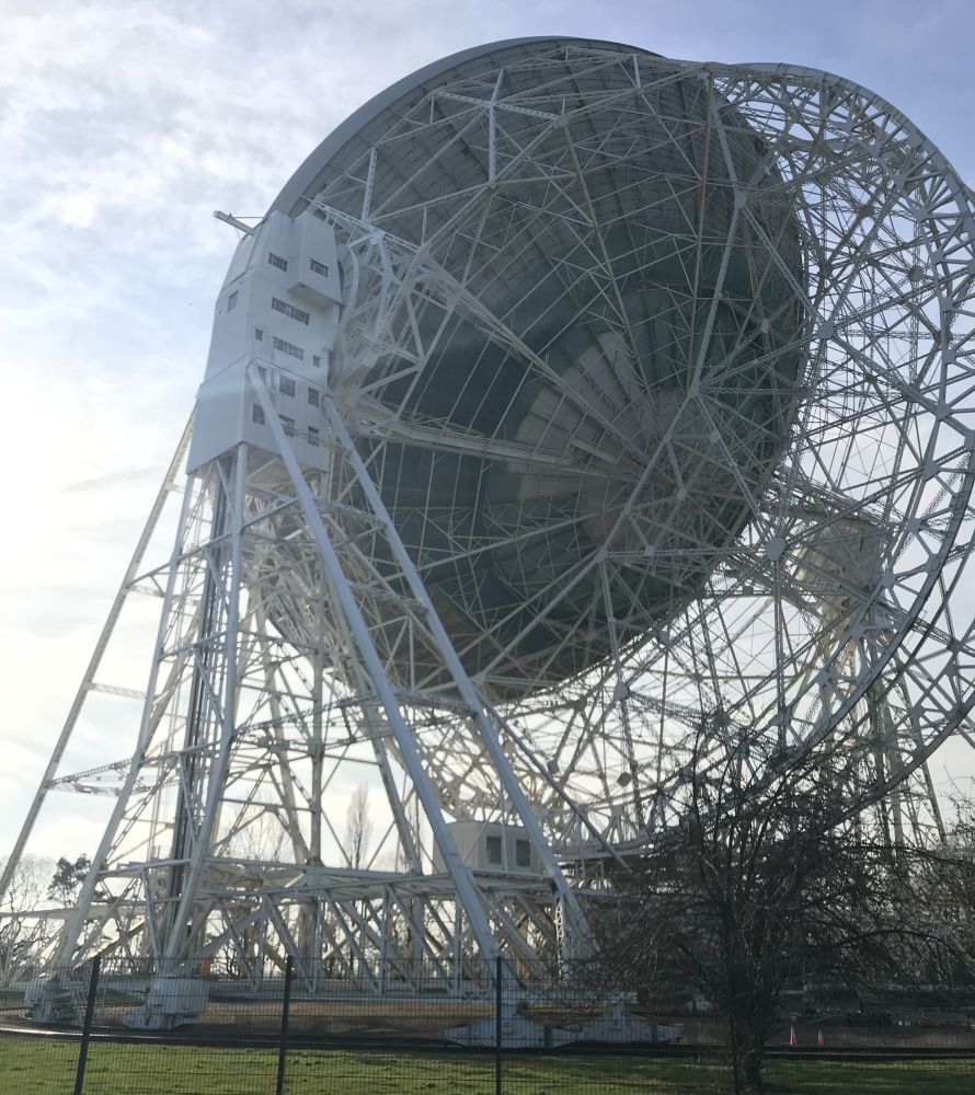 Looking up at the large satellite dish installation.